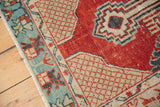 Abrashed cherry red field and playful, primitive aqua border of a vintage Oushak runner.
