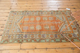 Distressed Oushak rug corner, tangerine, mint, mauve geometric floral palmettes and stepped spandrel.