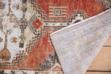 Vintage distressed Oushak rug runner, revealing worn cherry red pile and hand-knotted reverse.