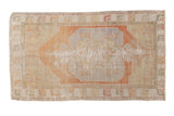 Distressed vintage Oushak rug with faded terra cotta medallion, pale blue accents, and visible foundation wear.