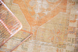 Distressed Oushak rug showing visible knot heads and faded terra cotta, sand colors.
