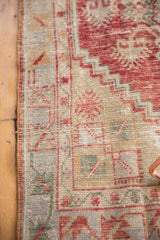 Cherry red serrated shrub motifs and meandering vine on a distressed vintage Oushak runner.