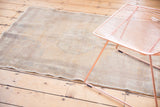 Intact side cord selvage and even pile wear on this neutral distressed Oushak rug.