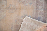 Hand-knotted vintage Oushak rug showcasing its distressed texture and woven foundation.