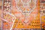Distressed Oushak rug section with vibrant tangerine, saffron, and low pile curvilinear motifs.