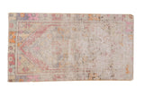 Vintage distressed Oushak rug, faded diamond medallion, geometric border, soft pink, purple, and silver.