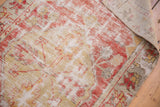 Distressed vintage Oushak rug, cherry red and saffron patterns, showing texture and woven reverse.