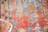 Textured vintage Oushak rug runner with distressed cinnabar red, slate blue, and ivory pile.