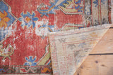 Textured, distressed cinnabar red pile of a vintage Oushak rug with hand-knotted reverse.