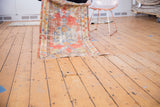 Vintage Oushak runner unfurled, showcasing distressed design with pale cinnabar red and slate blue.
