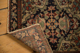 A folded corner on an antique Persian bag face reveals its even, low pile and hand-knotted foundation.