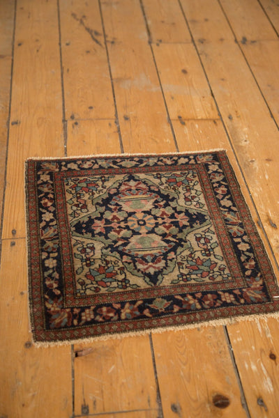 High-angle view of an antique Farahan Sarouk square rug with floral patterns measuring 1'8