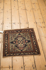 High-angle view of a square antique Farahan Sarouk rug, showing its complete floral pattern.