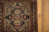 Intricate book cover spandrel and floral borders of a late 19th-century Farahan Sarouk rug.