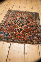 Vintage Farahan Sarouk rug mat's secured bottom edge and blue, red floral border.