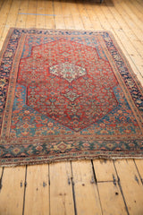 Antique Persian Bijar rug viewed from an angle, showcasing its balanced Herati design and rich colors.
