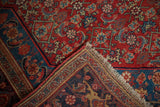Folded corner of an antique Persian Bijar showing its dense Herati motif and secured hand-knotted edge.