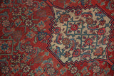 Close-up on the classic Herati motif and ivory medallion corner of an antique Persian Bijar rug.