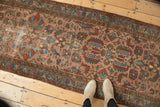 Hand-knotted antique Lilihan runner with rose, teal, and madder red floral motifs; shows wear.