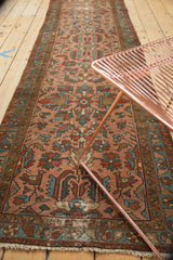Fringed end of antique Persian Lilihan runner, showing geometric bird and floral motifs in rose and teal.