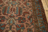 Antique Lilihan rug's geometric-floral field, showing rose, teal, and madder red motifs.