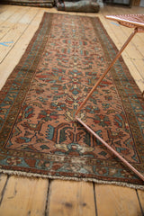 Antique Persian Lilihan runner with geometric floral patterns in rose, teal, and brown.