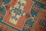 Geometric inverted niche pattern on antique Caucasian rug, madder root red, teal, and ivory.