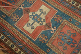 Antique Caucasian rug section with Farchalou Kazak double inverted niche design and storied wear.