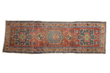 Antique hand-knotted Heriz runner, madder red field with geometric green and blue medallions.