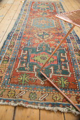 Geometric patterns of antique Heriz runner in cherry red, mallard green, and sky blue.