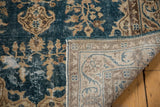 Distressed vintage Oushak rug showing sky blue pile wear, revealing detailed antique ivory hand-knotted foundation.