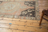 Distressed vintage Oushak runner with even wear, featuring blush, charcoal, ivory patterns.