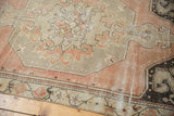 Distressed vintage Oushak rug with blush and ivory patterns, showing faint foundation and wear.