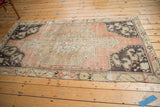 Distressed Oushak rug runner with artfully worn texture in blush, charcoal, and ivory hues.
