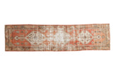 Vintage Distressed Oushak runner with faded brick red and light beige geometric medallions.