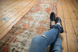 Distressed Oushak runner texture with faded brick red and foundation showing through.