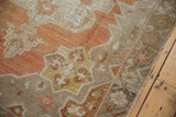 Detail of distressed vintage Oushak rug: sharp serrated contour, terra cotta, and even wear.