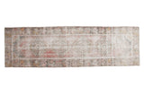 Distressed Oushak runner with faded medallions, floral borders, raspberry and ivory colors.