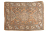 Distressed vintage Melas rug with a geometric medallion, bronze, ivory, and soft green hues, 4'6