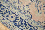 Distressed navy blue border, light beige band, faded apricot field of vintage Oushak carpet.