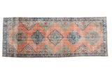 Distressed vintage Oushak rug runner with a blush peach field, blue, and mint green alternating medallions, 4'11