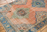 Distressed peach Oushak runner showcasing textured field and blue floral border.