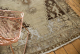 Distressed vintage Oushak runner with areas of foundation showing through its beige field.