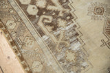 Distressed vintage Oushak runner with geometric border and abstract faded brown patterns.