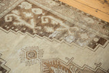 Distressed vintage Oushak runner detail with beige, brown primitive tendrils, and visible foundation wear.