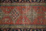 Antique Heriz runner detail: madder red field, aqua spandrel, pinwheel motifs, even foundation wear.
