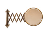Antique beveled glass accordion shaving mirror with fleur de lis hardware and darkened metal patina.