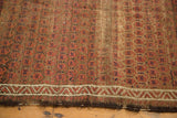 Belouch rug's madder red boteh field, ivory zig-zag river border, and fringed end.