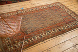 Antique Northwest Persian rug corner, madder red border with ivory floral botehs, visible knot heads.