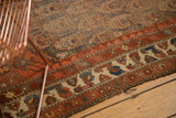 Antique Northwest Persian rug border with madder red, ivory motifs, blue details, and low pile texture.